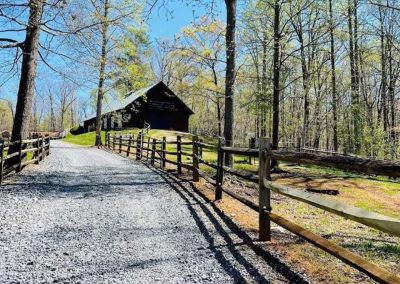Outdoor space at a picturesque farm wedding ceremony and reception venue, surrounded by trees in Lynchburg, Va. The Cliffside Barn at Disenhouse is perfect for spring weddings.