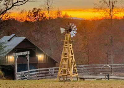 Golden hour bathes a small wedding venue in Lynchburg, VA, with warm light. Disenhouse Farm hosts barn weddings between 10 a.m. and 7 p.m.