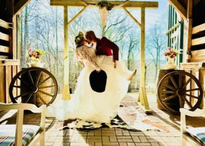 The bride and groom kiss at their micro wedding venue in Virginia.